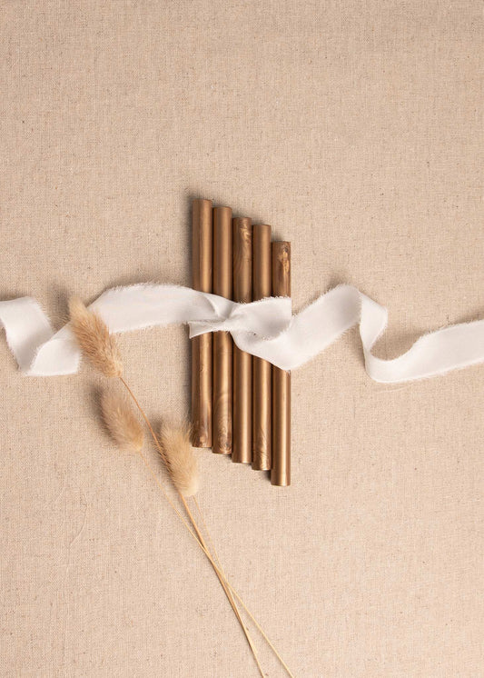 5 pack Bronze wax sealing sticks on linen background with silk white ribbon and dried flowers