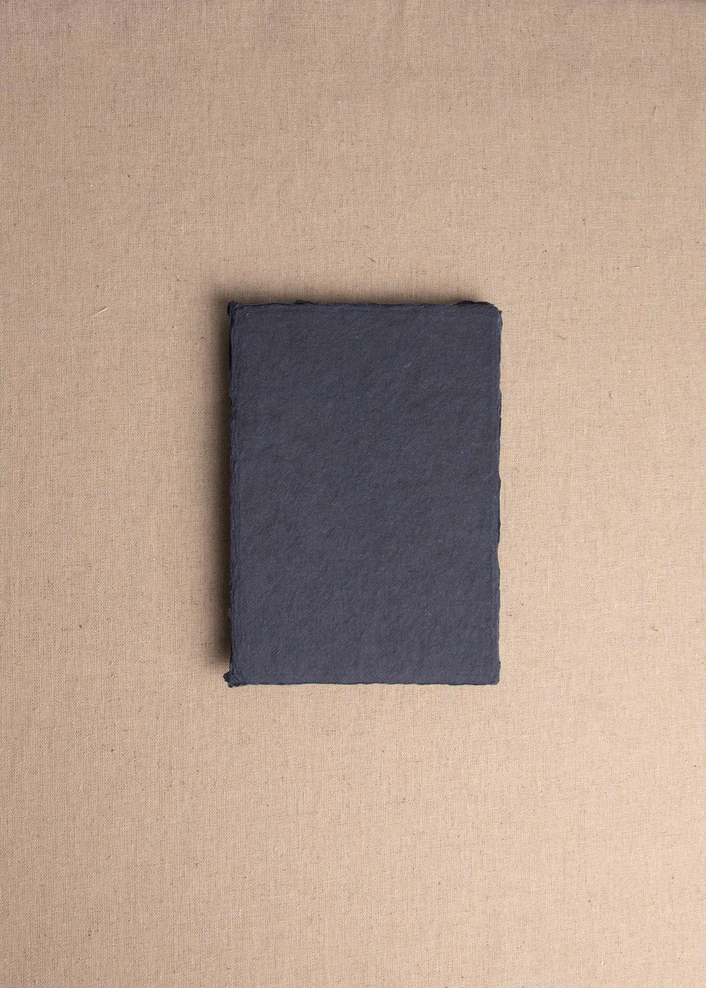 Singular 5x7 Dark Blue Handmade paper envelope with deckle edge on linen background