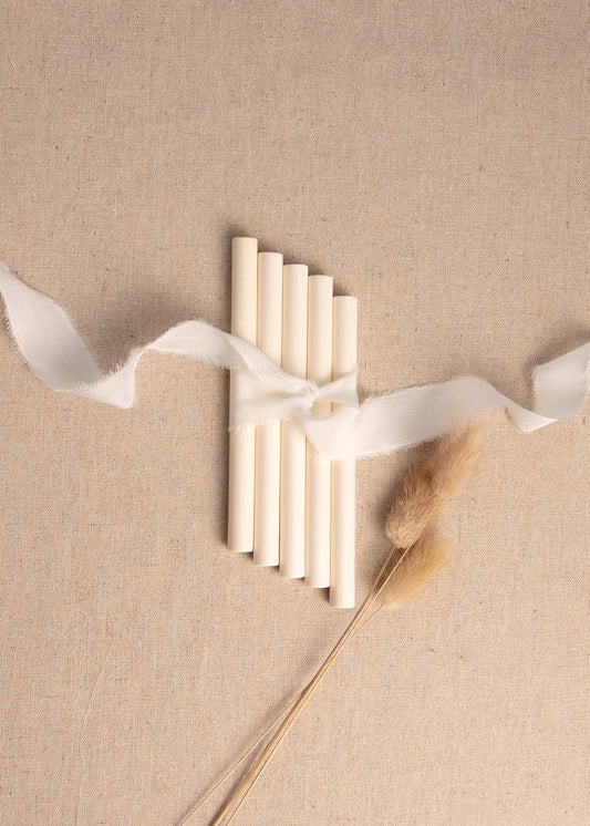 Antique Cream sealing wax sticks on linen background with white silk ribbon and dried flowers