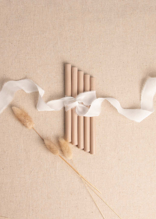 Beach Sands wax sealing stick on linen background surrounded by white ribbon and dried flowers