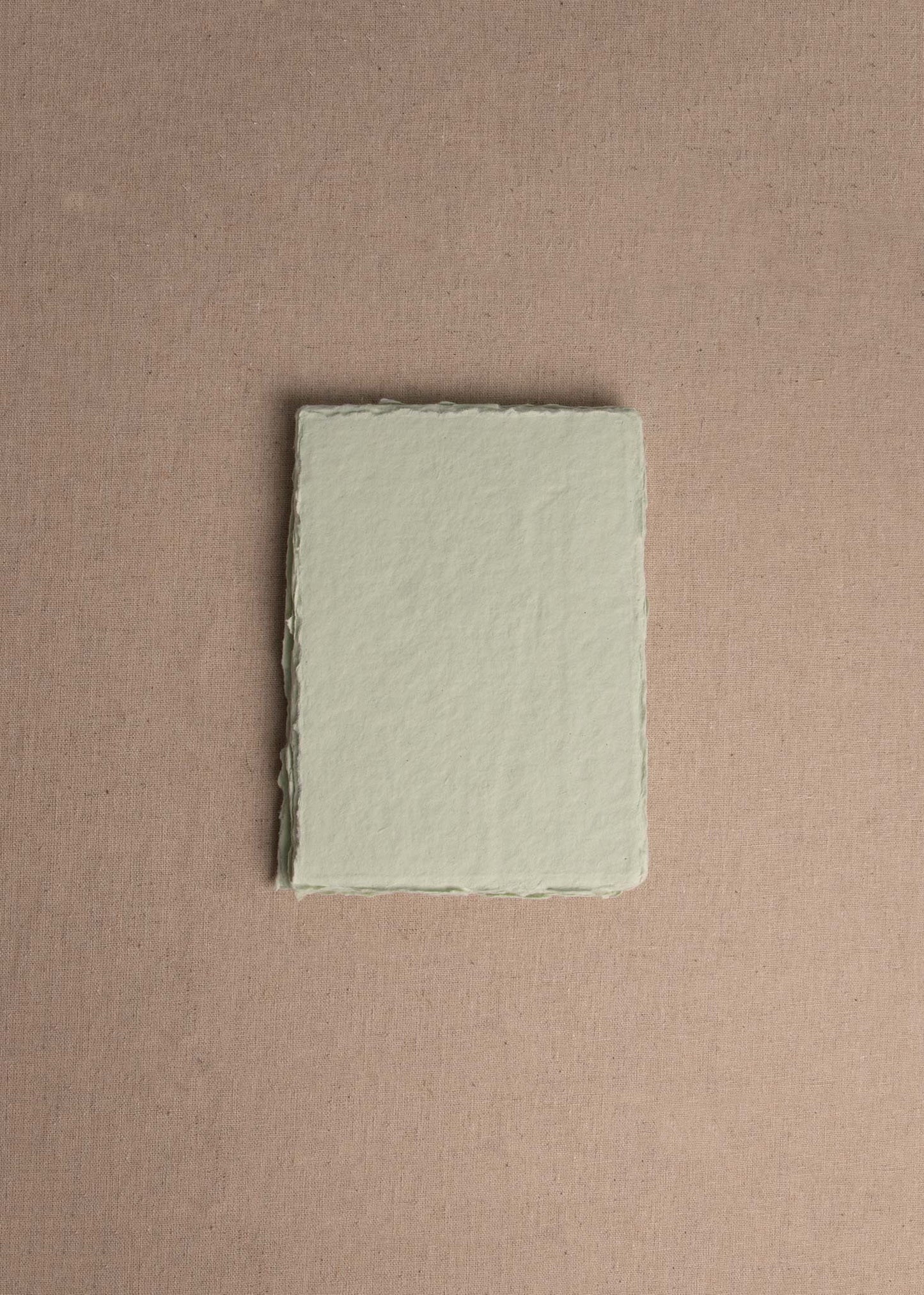 Singular 5x7 Mint Green Handmade paper with deckle edge on linen background
