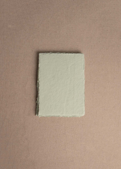 Singular 5x7 Mint Green Handmade paper with deckle edge on linen background