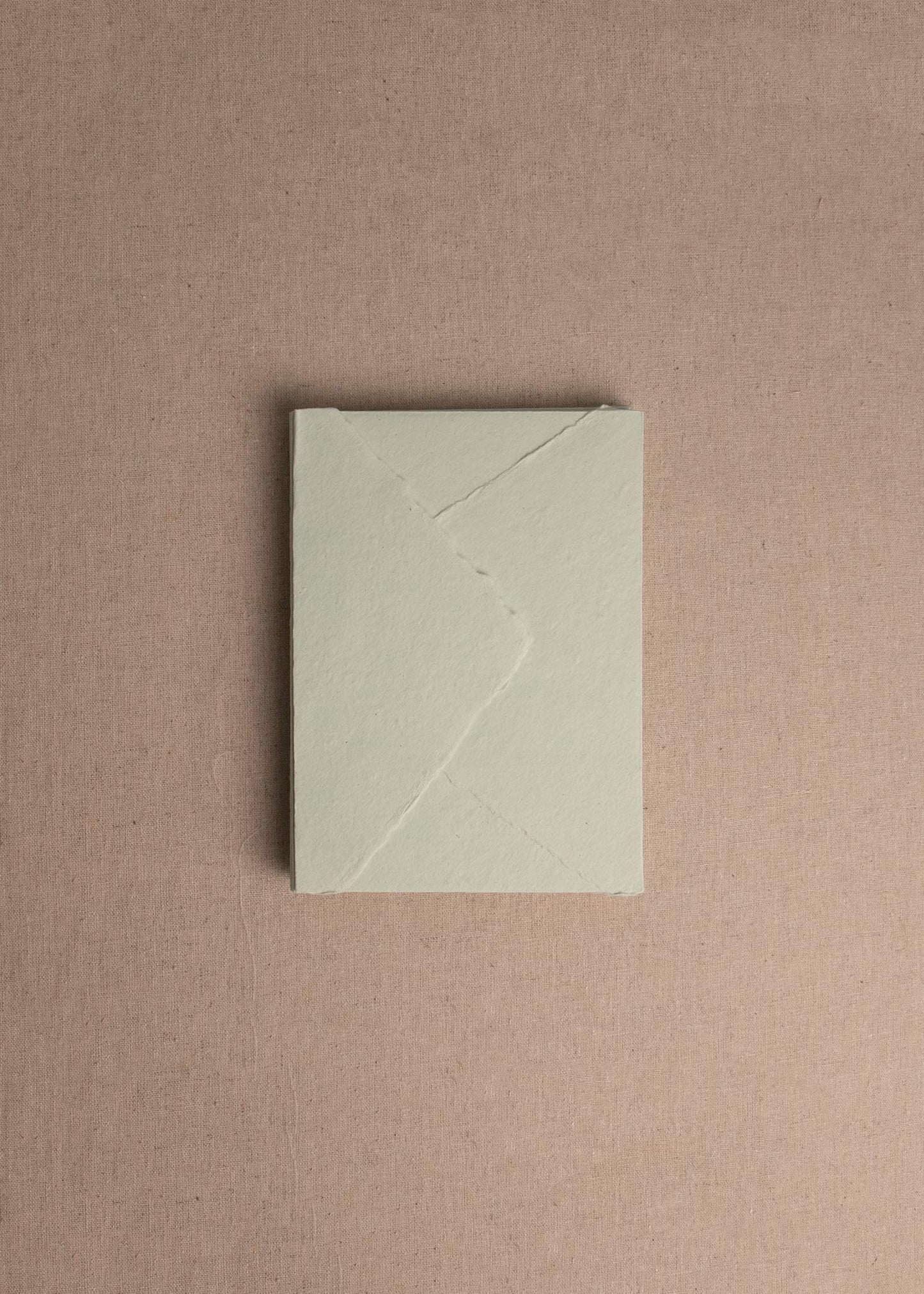 Singular 5x7 Mint Green Handmade paper envelope with deckle edge on linen background