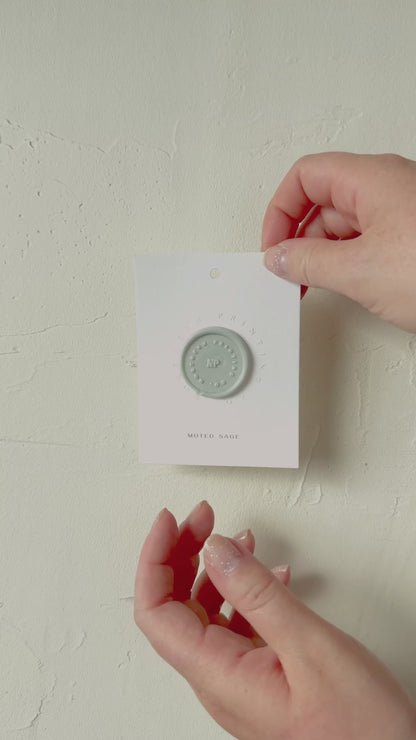 Video of Muted Sage wax seal stamp sample on textured background