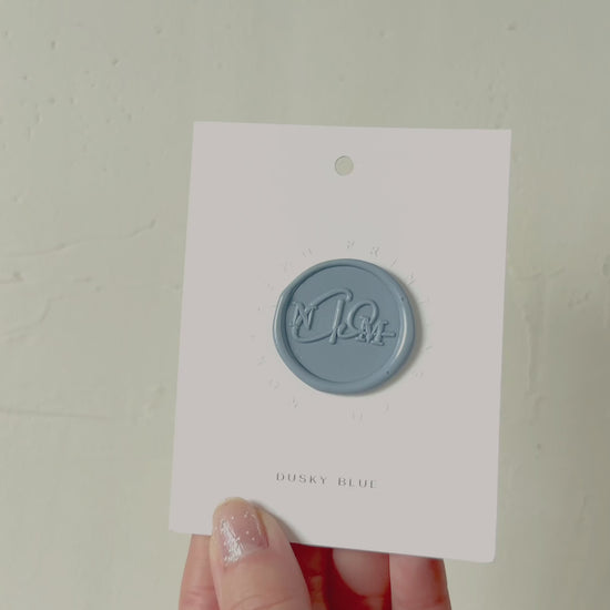 Video of Dusky Blue wax seal stamp sample on textured background