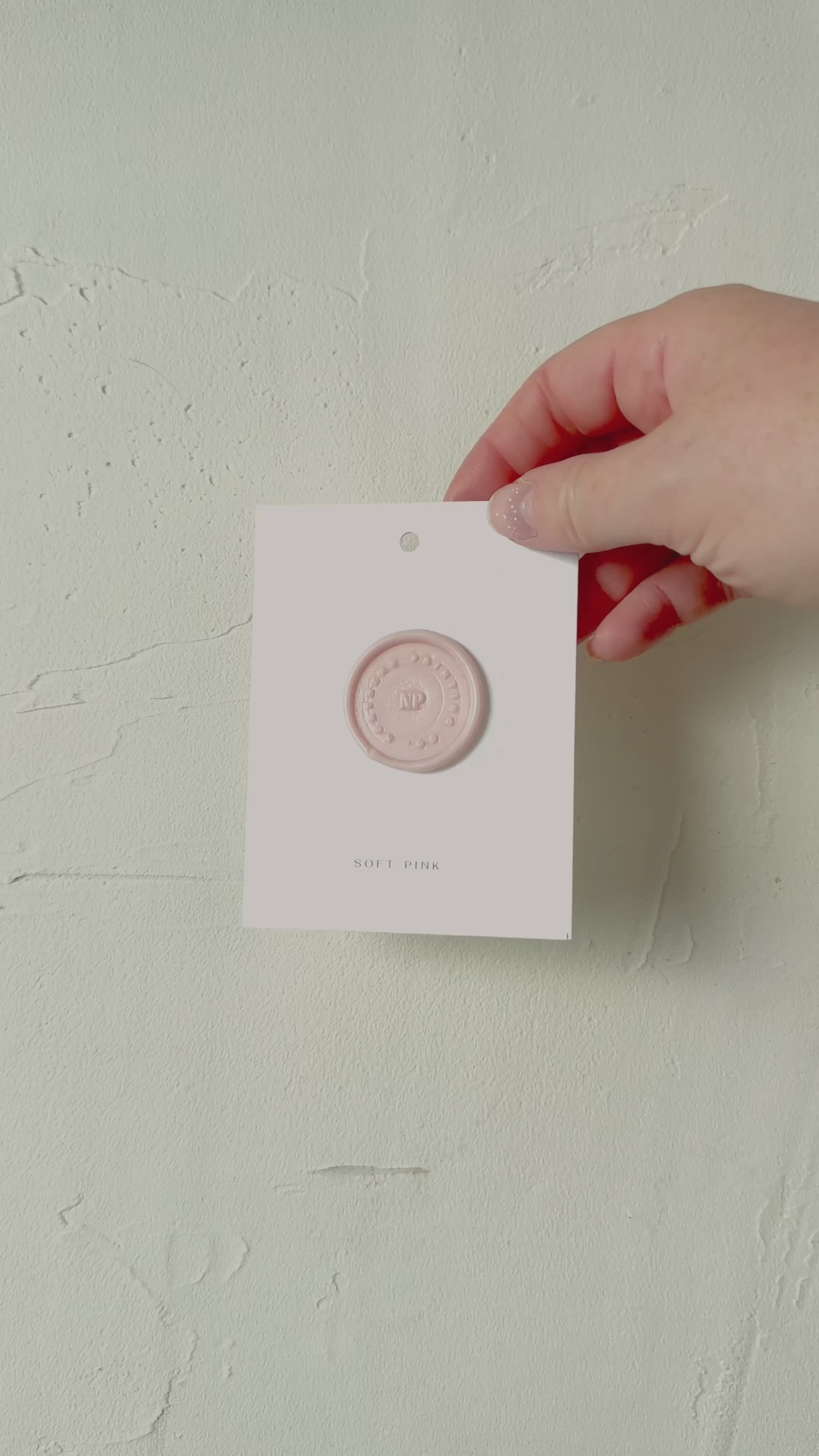 Video of Soft Pink wax seal stamp sample on textured background