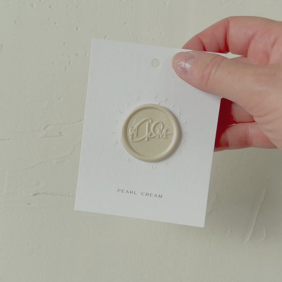 Video of Pearl Cream wax seal stamp sample on textured background