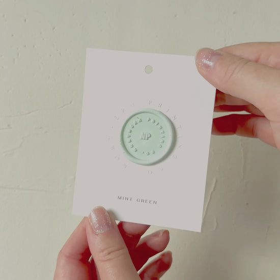 Video of Mint Green wax seal stamp sample on textured background