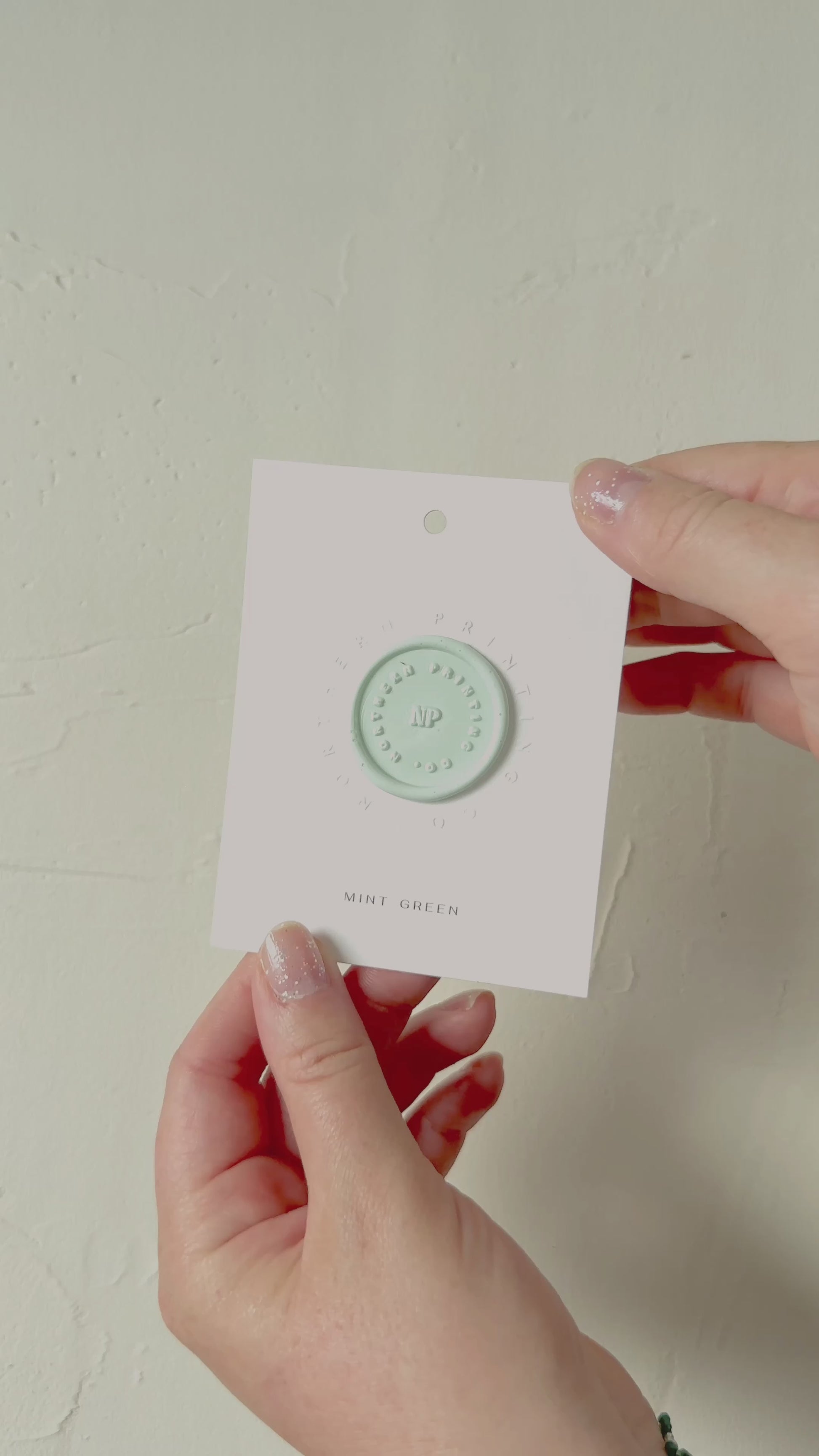 Video of Mint Green wax seal stamp sample on textured background