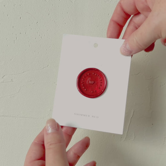 Video of Shimmer Red wax seal stamp sample on textured background