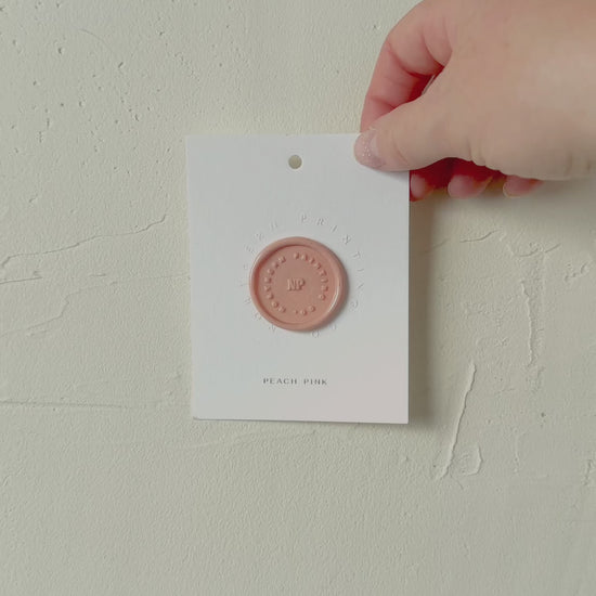 Video of Peach Pink wax seal stamp sample on textured background