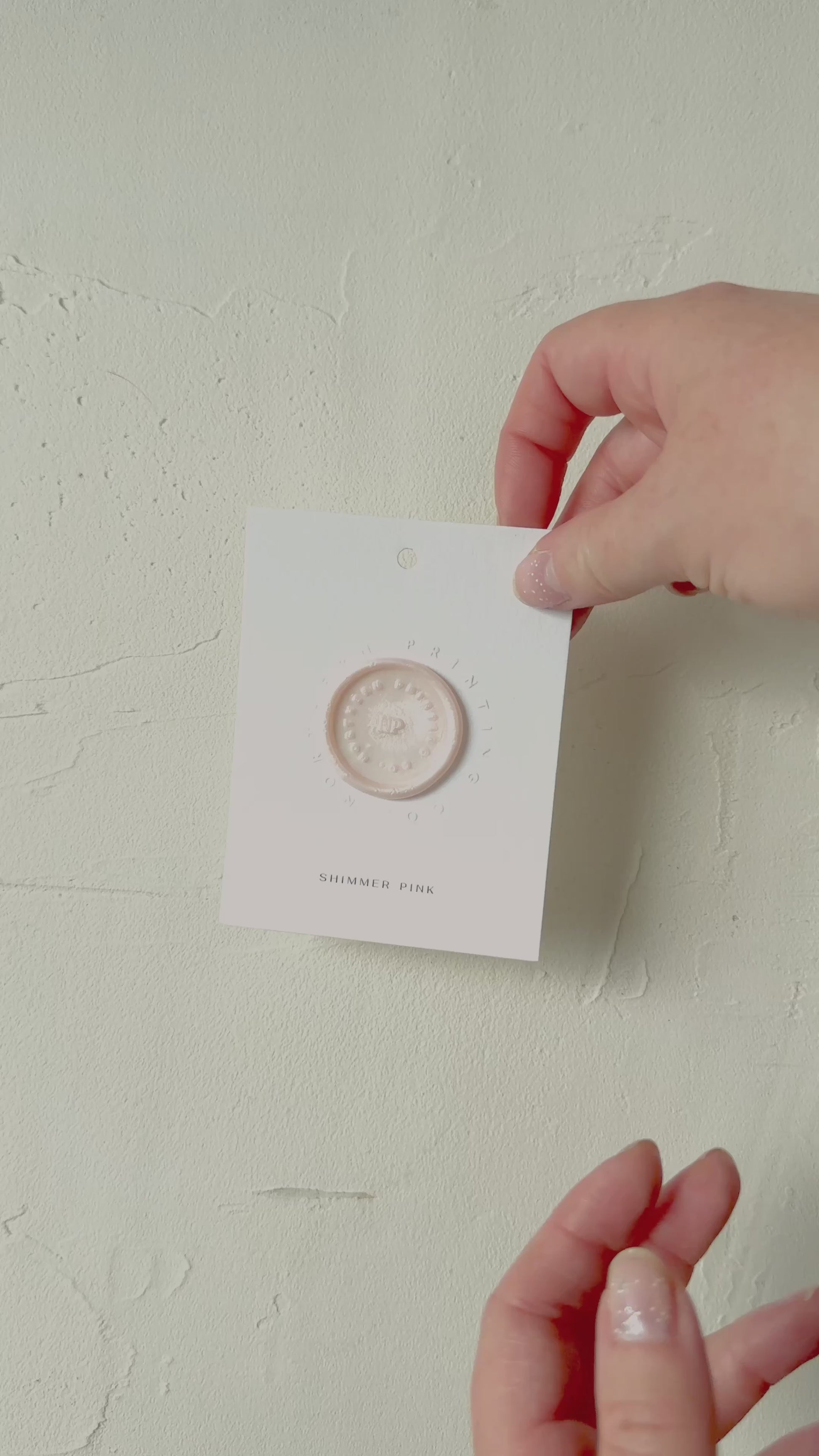 Video of Shimmer Pink wax seal stamp sample on textured background
