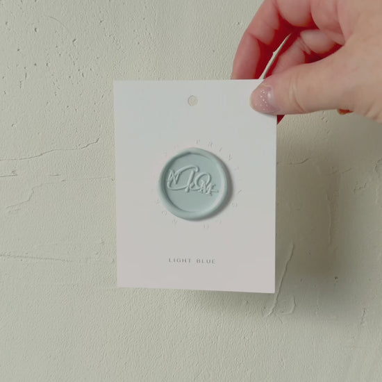 Video of Light Blue wax seal stamp sample on textured background