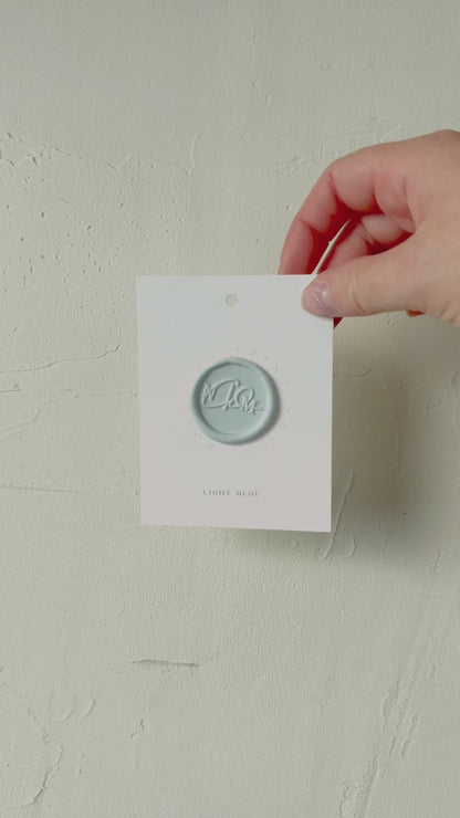 Video of Light Blue wax seal stamp sample on textured background