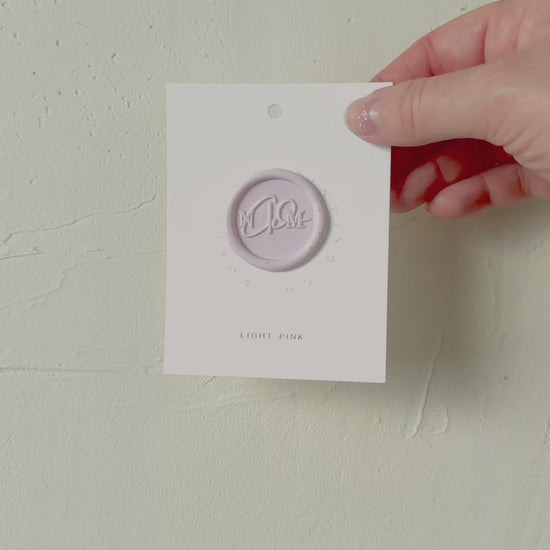 Video of Light Pink wax seal stamp sample on textured background