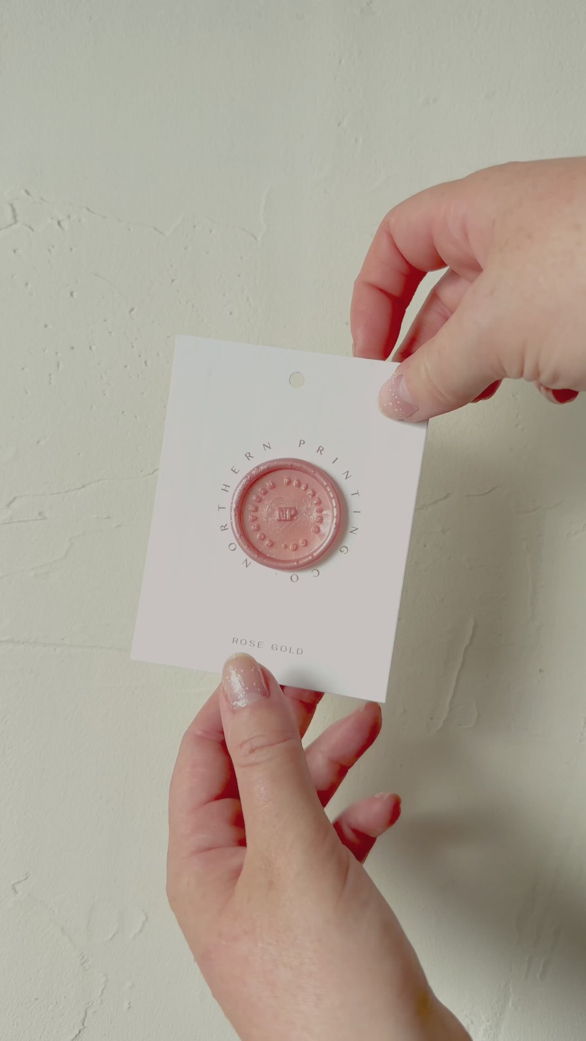 Video of Rose Gold wax seal stamp sample on textured background