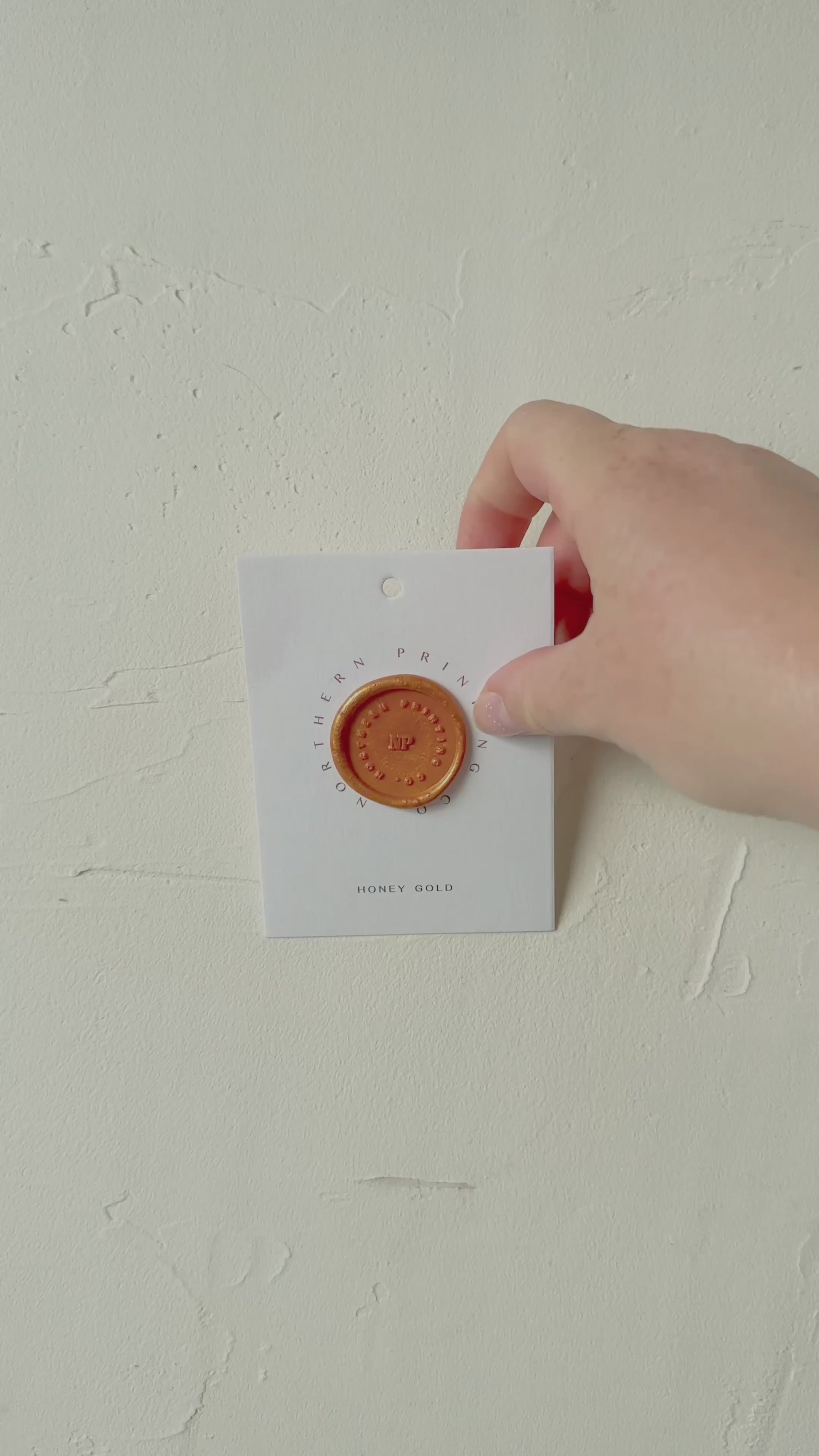 Video of Honey Gold wax seal stamp sample on textured background