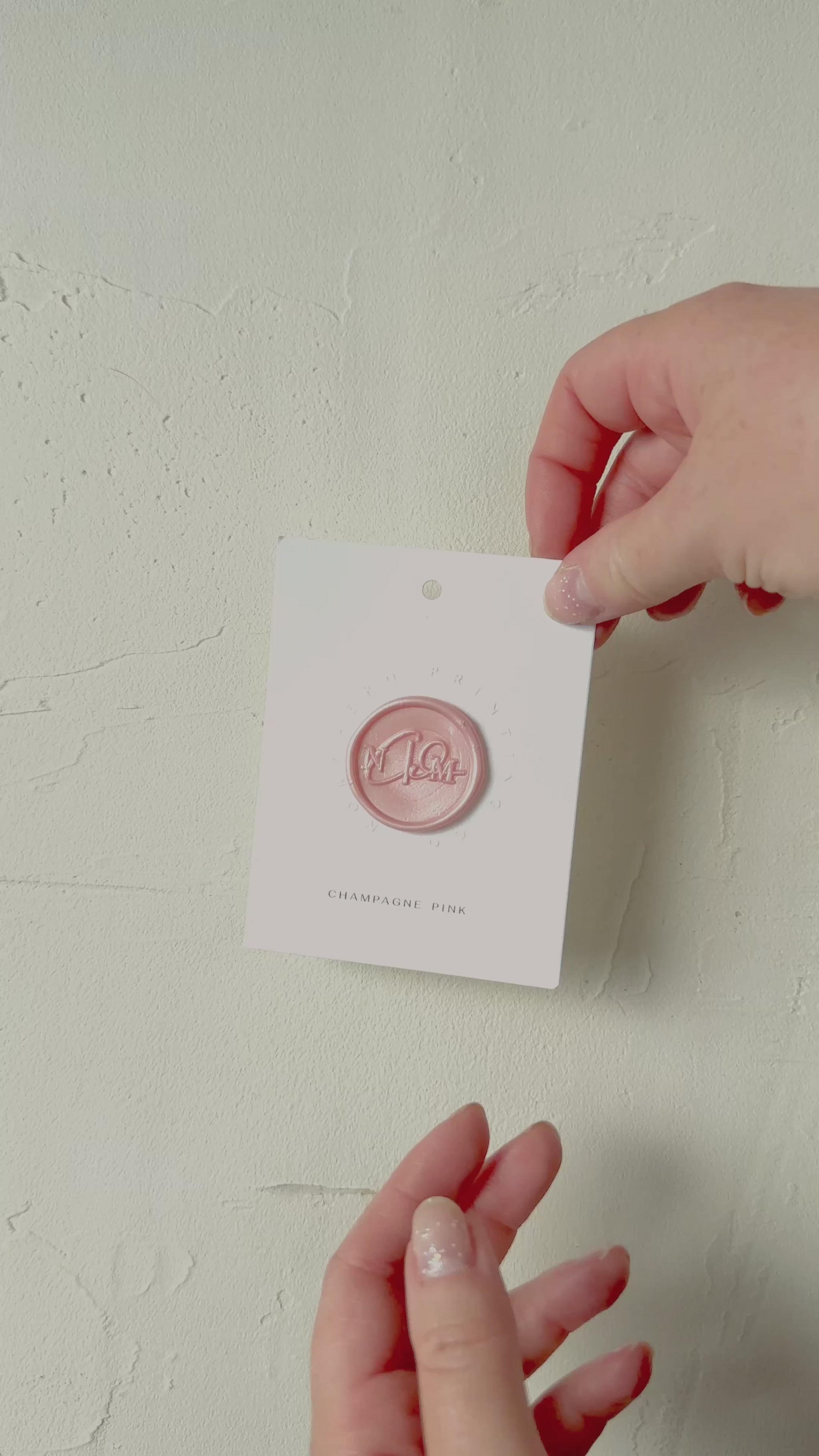 Video of Champagne Pink wax seal stamp sample on textured background