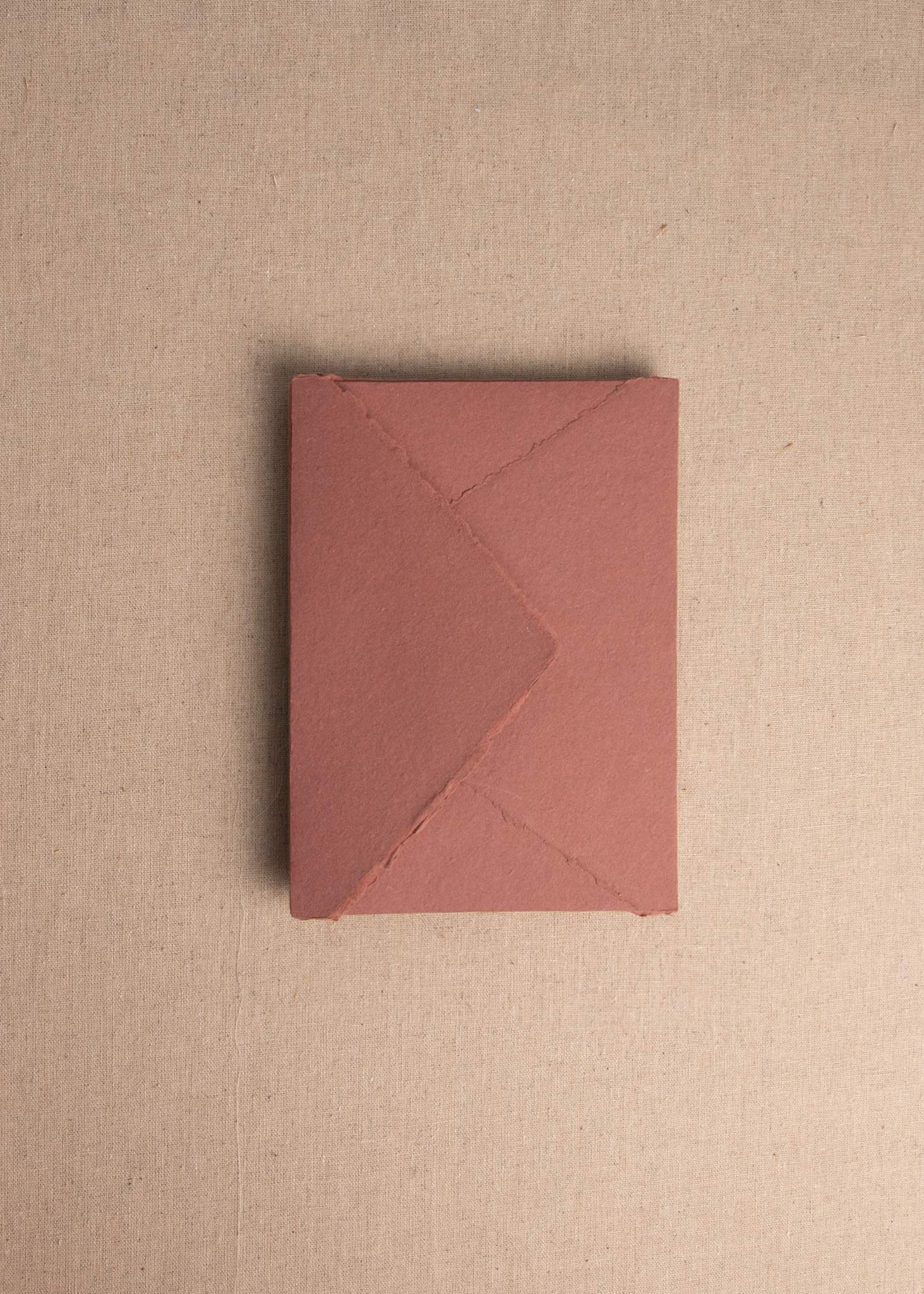 Singular 5x7 Rose Handmade paper envelope with deckle edge on linen background