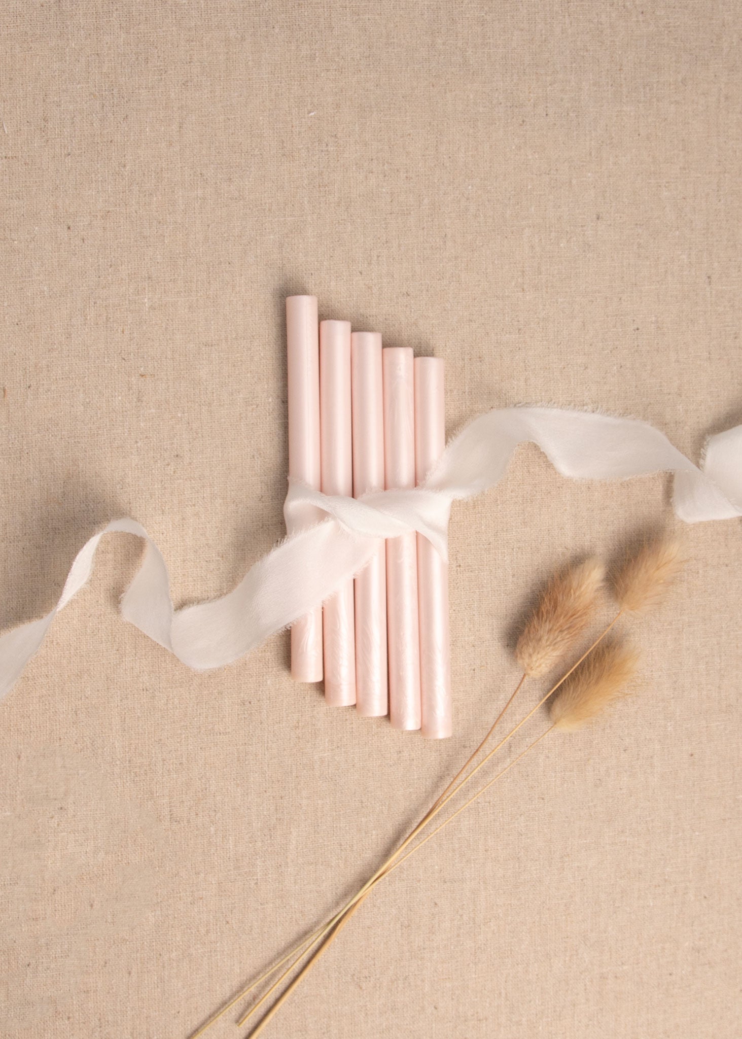 5 Shimmer pink wax seal sticks tied together with white ribbon and dried flowers 