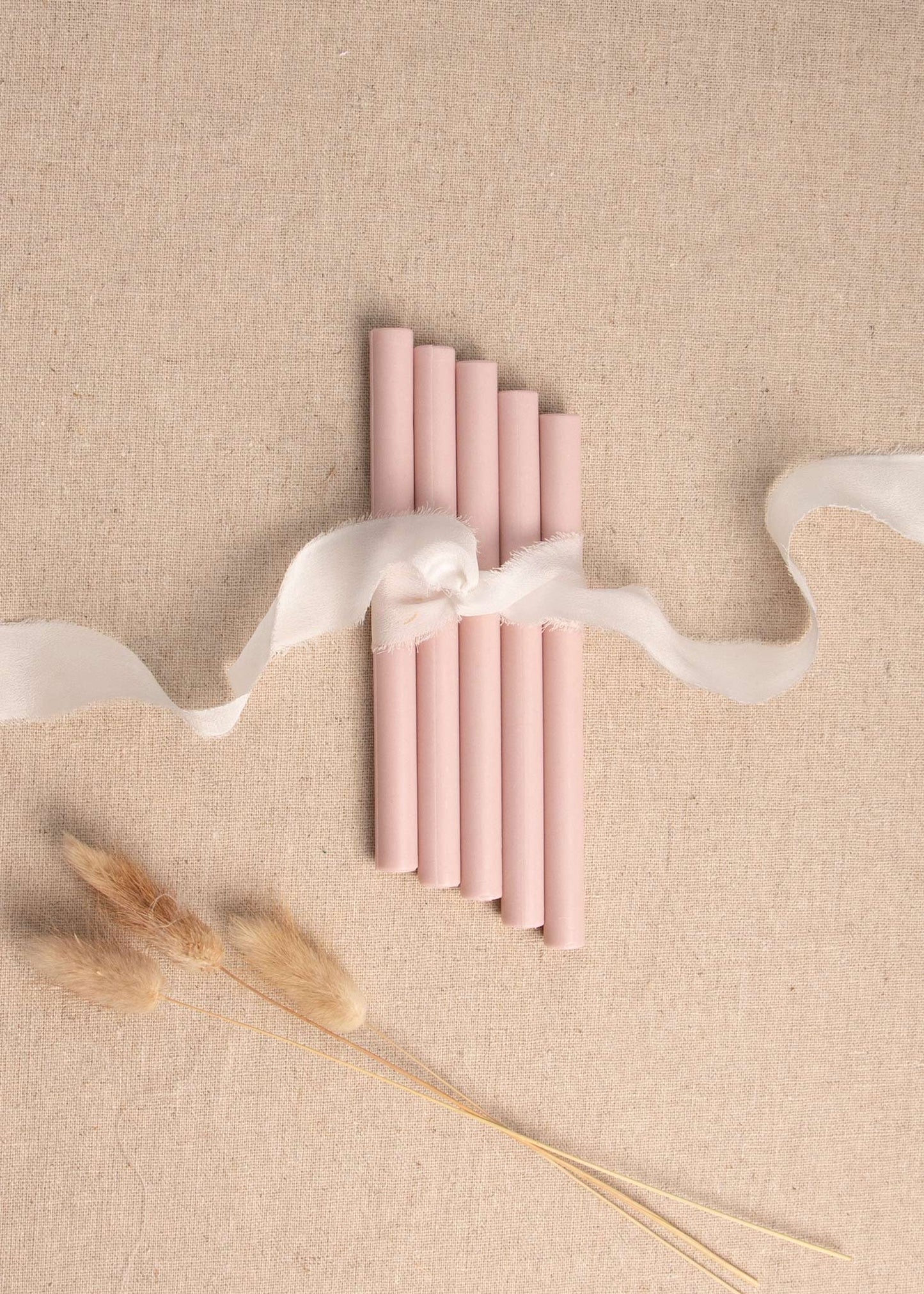 5 soft pink wax seal sticks tied with white silk ribbon and dried flowers 